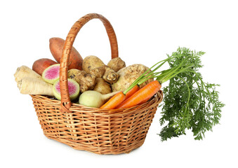 Different root vegetables in wicker basket isolated on white