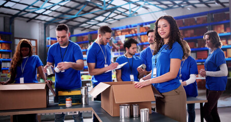 Diverse volunteers at charity foundation pack food donations