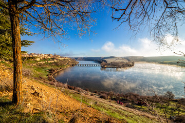 The medieval village of Maderuelo and the long bridge across the Linares del Arroyo swamp.
