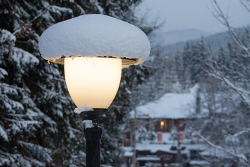 Street lamp under the snow in winter. Snowy weather, blizzard.
