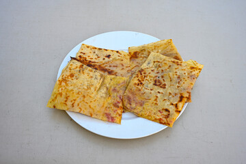 Freshly baked appetizing Turkish tortillas - Gozleme with spinach, cheese  on a white board. Space for text. Handmade Turkish traditional pastries. Ispanakli, otlu peynirli gozleme. Tahinli Katmer