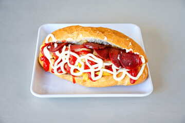 Close-up shot of Izmir's famous Turkish Traditional Kumru Sandwich, Ceşme Kumru, patso ingredients ready to eat salami, soudjouk, tomato, cheddar cheese and fried cheese. Yengen sandvic. Izmir karisik