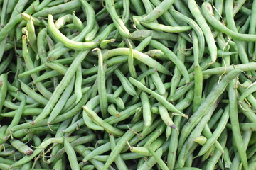 fresh green beans laying on market.