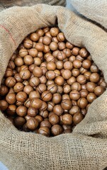 The ripened in-shell nuts are filled into large bags for sale at the city market