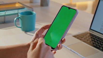 Businesswoman hands scrolling chroma key mobile phone at workplace closeup. 