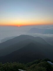 The sunrise casts a beautiful glow over the mountains.