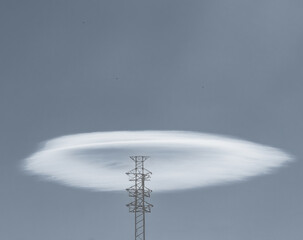 Lenticular cloud over a high-voltage tower