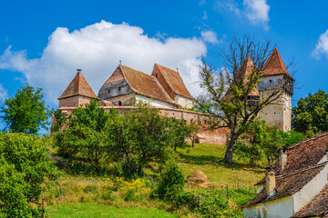 Fototapeta premium Saxon evangelical fortified church in Alma Vii village in Sibiu county, Transylvania, Romania
