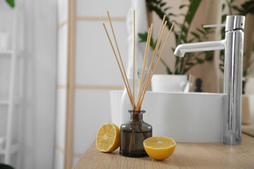 Citrus reed diffuser on table in bathroom
