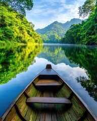 Obraz premium Kaeng Krachan National Park, Phetchaburi, Thailand - A tranquil sunrise over the Kaeng Krachan reservoir, with soft morning mist hovering above the still water, surrounded by lush