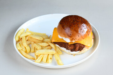 Big tasty burger with beef cutlet on a plate. Hamburger, cheeseburger with mushroom. Hamburger, Mexica, mushroom double burger.  Crispy chicken burger. With french fries, patates kizartmasi.