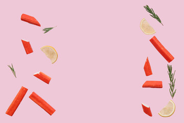 Tasty crab sticks with rosemary and slices of lemon flying on pink background © Pixel-Shot