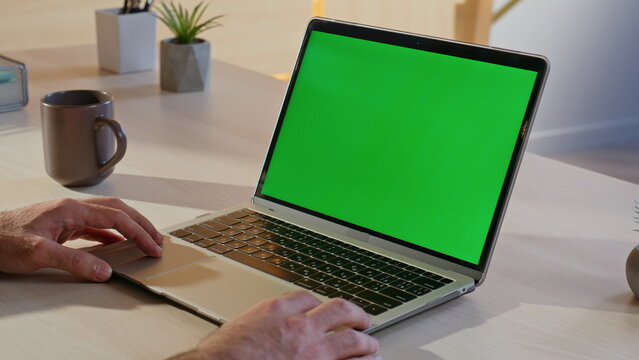 Entrepreneur watching video green screen laptop at remote workspace closeup.