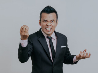 Angry Asian boss manager businessman in black suit, isolated over white background.