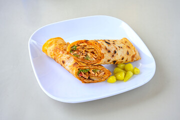 Lavash doner kebab ( soslu kasarli zurna doner durum )  or shawarma sliced in plate isolated.  Tavuk Et Doner Durum. Hatay Iskenderun usulu bazuka tavuk doner durum. 