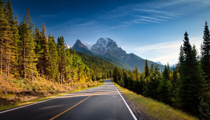 Fototapeta premium scenic road through forest towards mountain