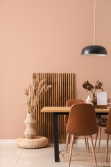 Interior of dining room with table, lamp and folding screen