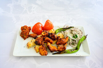 Chicken wings barbeque in a dish with BBQ grill sauce . Izgara tavuk kelebek sis kanat. Izgara tavuk sis, gogus.