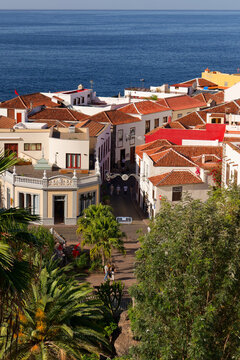 Beautiful town square in Garachico Plaza Juan Gonzalez de la Torre. Above green public park towards historical seaside town in Tenerife. Calm Atlantic ocean on as sunny day in winter.