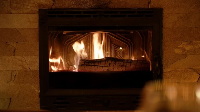 A tranquil fireplace flickers softly, casting warm light on coffee-beige tiles. The subtle glow enhances a cozy atmosphere, each flame reflection dancing across the polished surface.