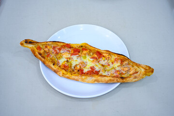 Kiymali pide.Turkish pide with minced meat. Turkish pizza mince pita Pide on white . Etli ekmek.Kusbasi kasarli, kiymali kasarli, kiymali yumurtali, Bafra, Trabzon, Kusbasili pide. Urfa acili lahmacun