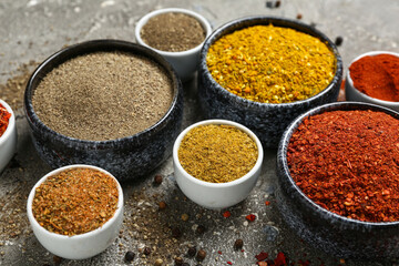Composition with bowls of different spices on grunge background