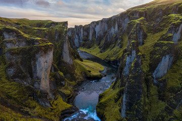Birdview of Fjadrargljufur canyon with a river meandering through the middle of the canyon. Color landscape in a famous place in Iceland. Scenic nature environment.
