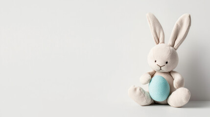 Obraz premium easter gift ideas kid. Soft pastel Easter bunny plush with blue egg, perfect for spring