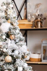 New Year tree with snow on branches with black shelf. decoration in the room with a Christmas tree