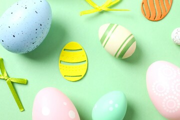 Happy Easter card. Easter eggs and decoration on color background, top view