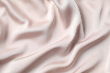 Beige silk satin. Shiny smooth fabric. Soft folds. Luxury background with space for design. Flat table, top view