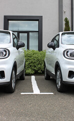 Same White Compact Electric Cars For Rent In Front Of Rental Office
