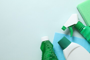 Many different house cleaning products on color background, top view