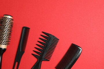 Professional combs and hairdresser tools on color background, top view