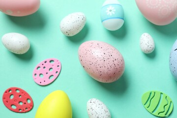 Happy Easter card. Easter eggs and decoration on color background, top view