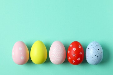 Happy Easter card. Easter eggs and decoration on color background, top view