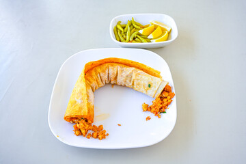 Meat, chicken shawarma kebab with yogurt and fried butter sauce .Tantuni Special. durum  Yogurtlu tantuni. Ekmek arasi tantuni. 