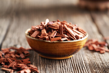 Red sandalwood chips in a wooden bowl