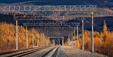 Railway tracks against a beautiful sunset and mountains. Transportation industry	
