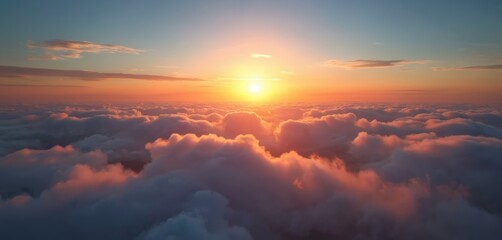Fototapeta premium Aerial view shows sunset above fluffy clouds. Sky is orange and blue. Sun creates golden hour effect. Calm serene scenic landscape is perfect for meditation practices.