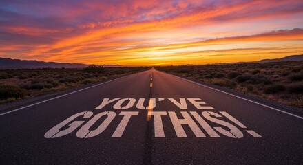 Road to Success Sunrise - Inspiring sunrise landscape photo depicting a road stretching towards the horizon with the motivational message "You've Got This!" painted on the asphalt. Symbolizing:  motiv