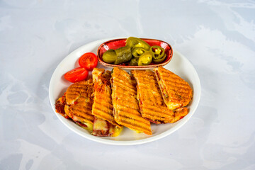 Turkish karisik atom Ayvalik tost ( kasarli bazlama tost) . Sucuklu, Kasarli, kavurmali karisik tost. Flat baked bread toasted. Karisik bazlama tost .  