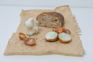 Homemade caraway bread and onions, a jar of lard on the table