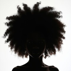 Fototapeta premium Silhouette of girl with curly hair on white background shows portrait of female. Model face in dark tones. African descent person with afro hairstyle. Haircare cosmetic product promo.