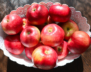 A bowl of apples is sitting on a table