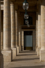 Obraz premium The colonnade corridors of Palais-Royal, where light and shadow dance on historic arches.