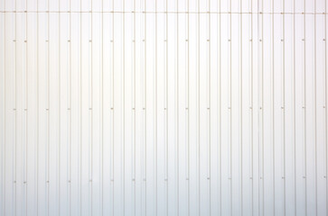 Corrugated steel warehouse or factory industrial building. Building wall, metal texture