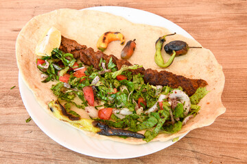 Grilled Turkish Adana, Urfa  Kebab with grilled vegetables, onion and rice on plate. Urfa, Adana durum.
