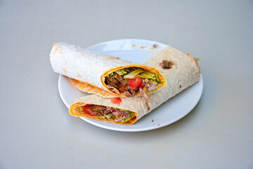 Grilled Turkish Adana, Urfa  Kebab with grilled vegetables, onion and rice on plate. Urfa, Adana durum.
