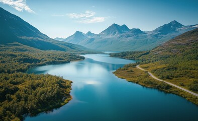Stunning aerial view of a tranquil lake surrounded by majestic mountains and lush green forests